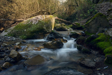 Fototapeta premium Long exposure photograph of the water in the Monachil River, in Los Cahorros. Monachil, Granada, Spain.