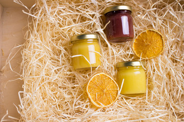 Honey in glass jar on a wooden floor. Background with fresh honey in clear glass jars.