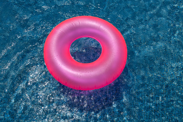 Pink swim ring on cyan water