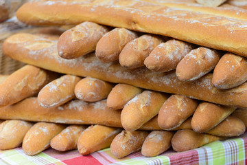 Fresh white baguettes stacked on a market stall in Saint-Palais-sur-Mer, Charente-Maritime on the southwestern coast of France
