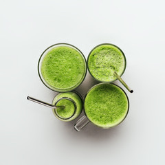 Cucumber vegan smoothie in many glasses, nutrient hydrating green juice, detox food, weight loss...
