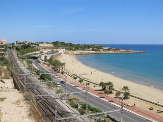 Fototapeta na wymiar Aerial view of Tarragona, Spain. View of the empty beach and railway