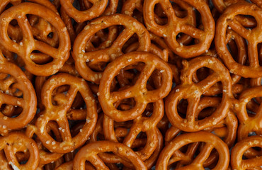 Fototapeta premium Mini pretzels with salt close-up. Traditional German beer appetizer. Culinary background. Selective focus, top view