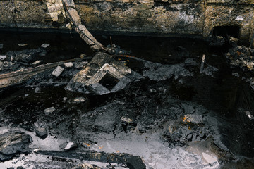 Destroyed building and oil spill. Pollution of nature.