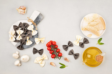 Flat lay with  traditional italian pasta farfalle and cooking ingredients. Traditional italian cusine concept.