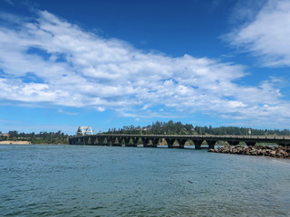Fototapeta na wymiar The Alsea Bay Bridge along coastal highway 101 connects Waldport and Bayshore on the Central Oregon Coast on a sunny spring day.