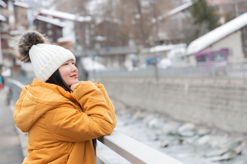 An Asian woman and her family are enjoying a winter snowy vacation and doing family activities in Zermatt Matterhorn in Switzerland.