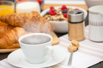 Breakfast Served in the morning with Hot black coffee and croissants Natural corn flake breakfast cereal in cups and fruit on the breakfast table every day