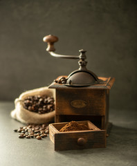 coffee grinder and beans on wooden background