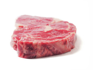 One raw fresh premium rib eye steak on white background.
