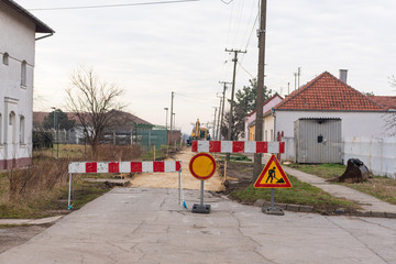 Workers with machinery preparing the road for new asphalt