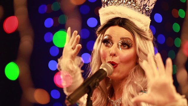 Video clip young woman singer in a New Year costume Snow Maiden sings a song in stage light