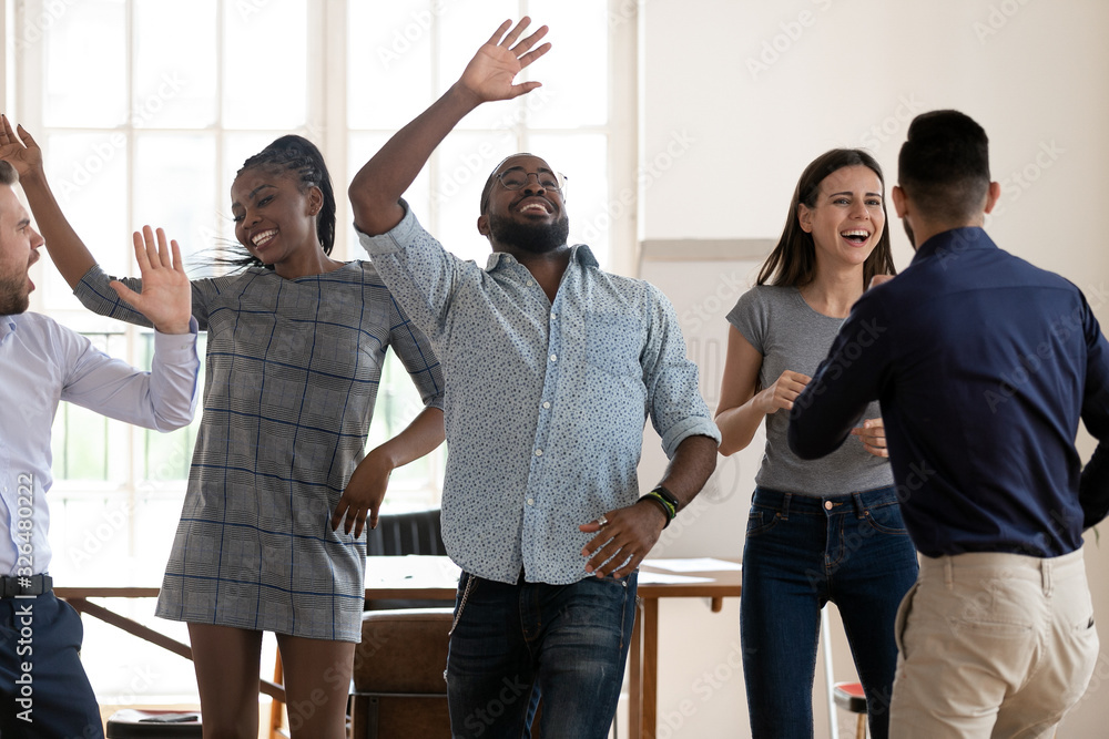 Wall mural excited multiracial team dancing celebrating success in business in office - Wall murals