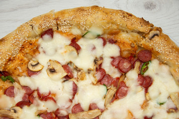 Pizza diavolo traditional italian meal from spicy salami peperoni chili onion olives and basil.