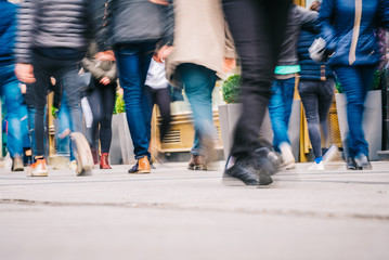 Crowd of people walking in motion in downtown rush hour
