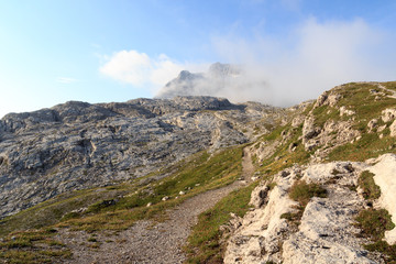 Fototapeta na wymiar Hiking path and mountain alps panorama in Brenta Dolomites with clouds, Italy