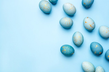 Easter frame of eggs painted in blue color. Flat lay, top view. Copy space for text.