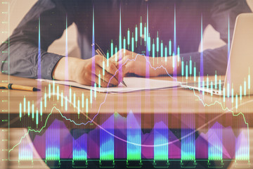 Double exposure hands with stock market chart.