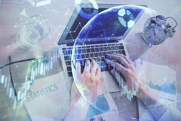 Multi exposure of forex graph with man working on computer on background. Concept of market analysis.