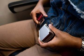 A female traveler on an airplane is wearing her seatbelt, safety first concept © Lucky7Trader