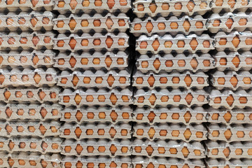 Fresh chicken eggs in a cardboard box from recycled waste paper. A lot of eggs in the package as an abstract background. Close-up. Concept.