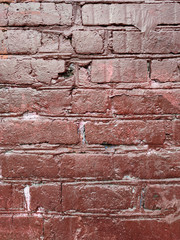 Painted brick wall of an architectural structure in brown. Fashionable texture.