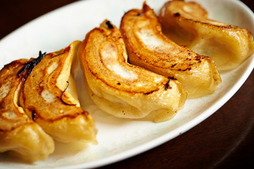 Pan fried dumpling on white plate