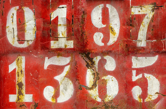 Numbers on an old rusty metal background. Texture of old paint and rust on the numbers