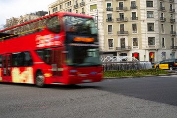 Red tourist bus circulating through the city.