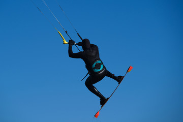 kitesurfer jumping on the blue sky