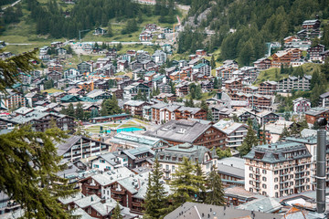 Wooden chalets and hotels in swiss village in Alps, Switzerland