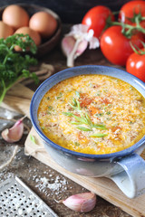 Italian cuisine. Stracciatella tomato soup: parsley, eggs and parmesan cheese