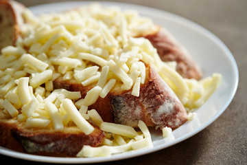 Melting cheese on baguette slice