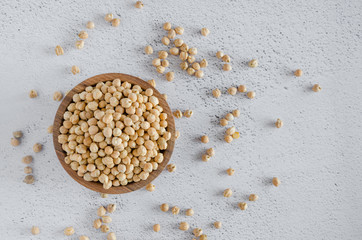 Raw Chickpeas on a wooden bowl on a light background. Chickpeas is nutritious food. Healthy and...