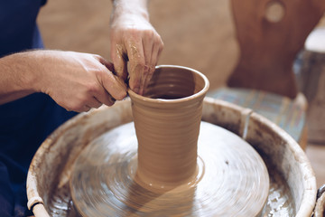 Potter making a clay vase on a potter's wheel