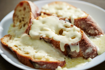 Melting cheese on baguette slice