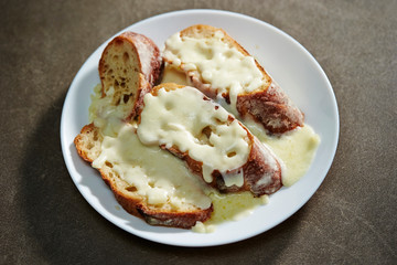 Melting cheese on baguette slice