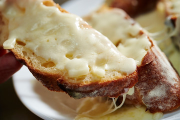 Melting cheese on baguette slice