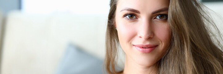 Obraz premium Close-up of wonderful sportswoman drinking protein shake. Beautiful female holding pink plastic bottle with water. Perfect model with long brunette hair. Sport and fitness concept