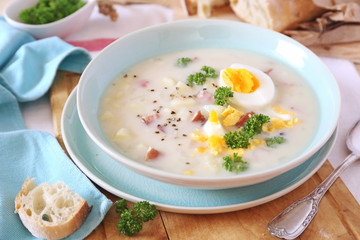 Traditional polish soup Zurek. Sour soup with sausage,  potatoes and eggs - 326492692
