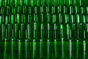 A lot of empty green red wine bottles.