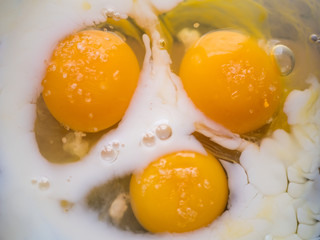 process of making omelet from natural eggs and products. Milk, salt, eggs. Cup for whipping omelet. Fork and knife. Frying pan and oil