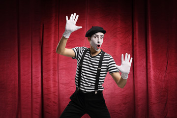 Mime pretending to touch an imaginary glass