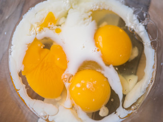 process of making omelet from natural eggs and products. Milk, salt, eggs. Cup for whipping omelet. Fork and knife. Frying pan and oil