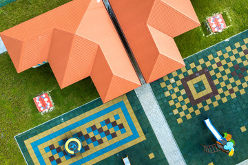 Aerial view of new alcove in kindergarten play yard with red tiled roof for outdoor children...