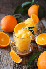 Orange granita, frozen summer dessert and  freshe orange fruits