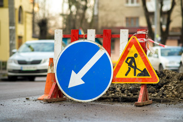 Warning street sign on road work site.