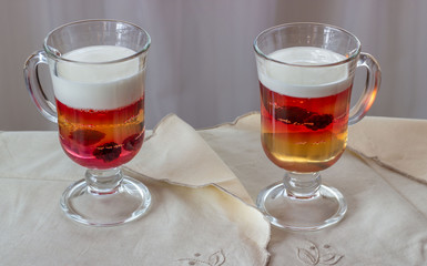 Multi-colored jelly and yogurt with the blackberries in a glass dessert bowl. Gelatin dessert for children. Delicious healthy food.