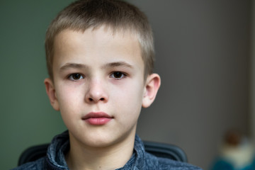 Closeup portrait of a serious child school boy.