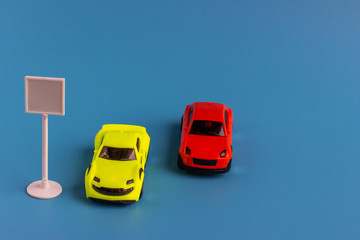 Small toy cars. Miniature children’s models of cars on a blue background.